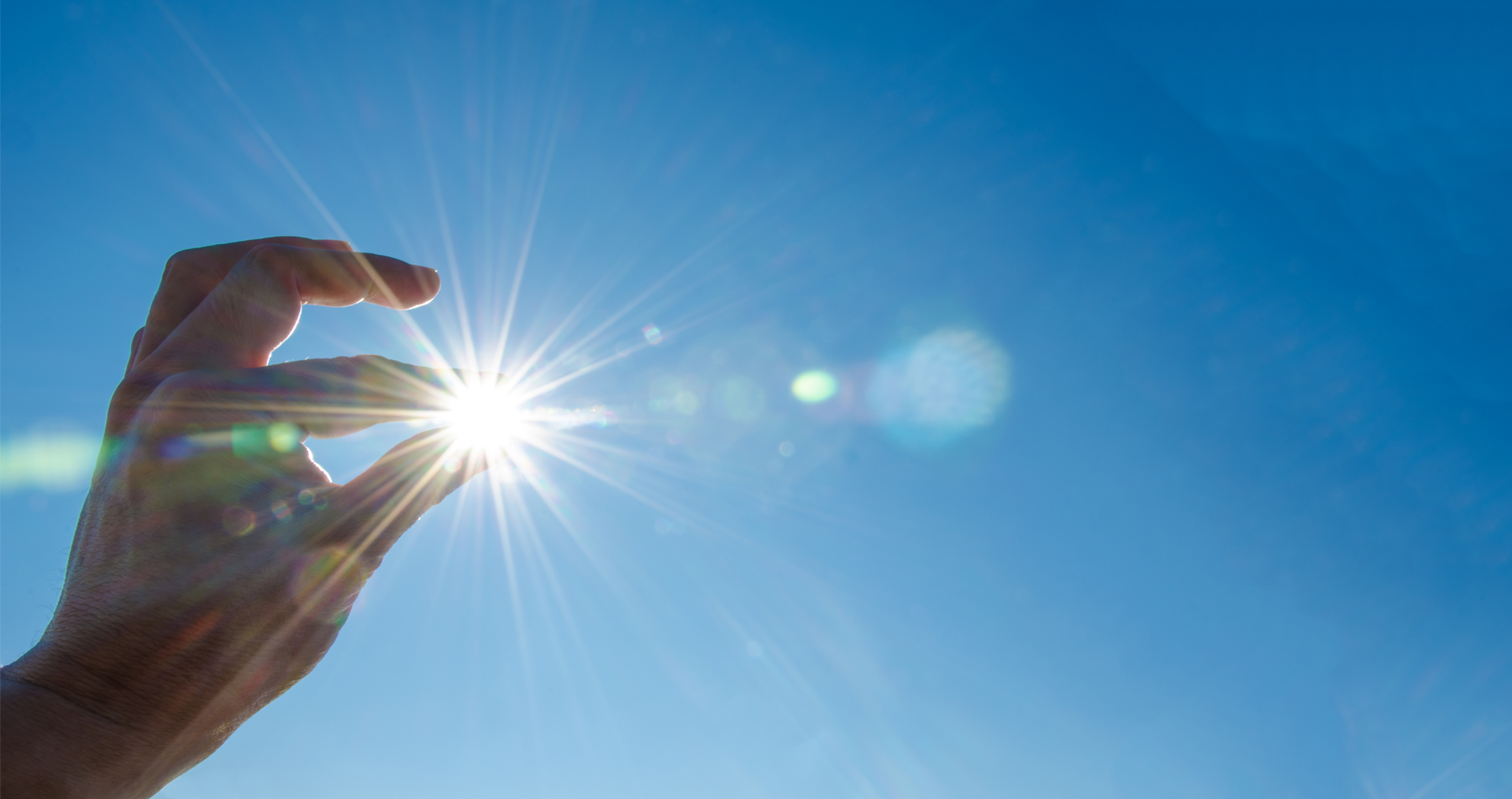 Sun shing through fingertips