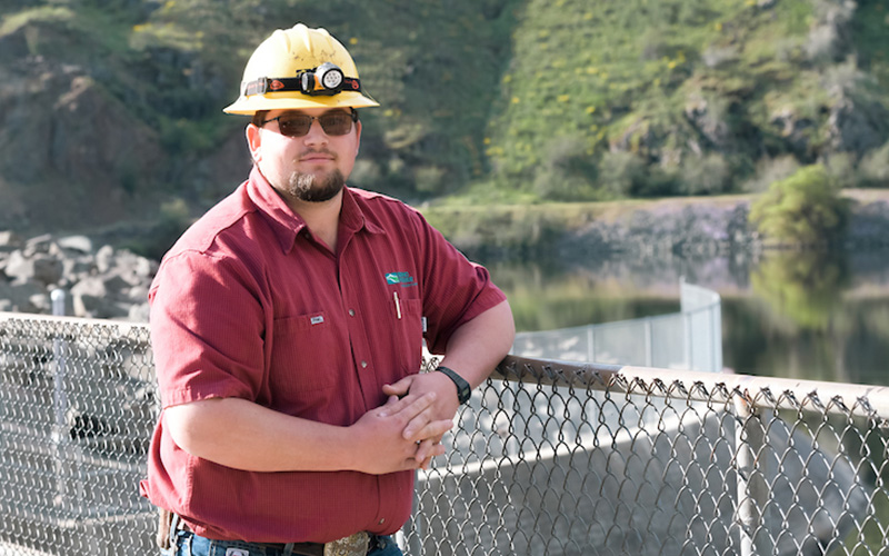 Generation apprentice standing next to a fence
