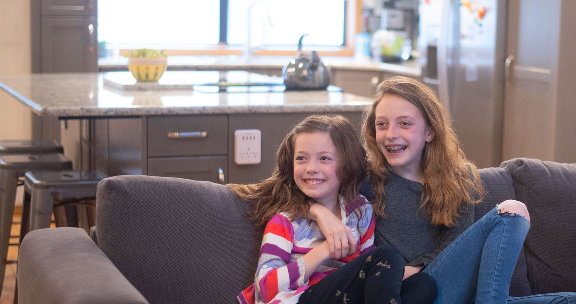 Two little girls sitting on the couch
