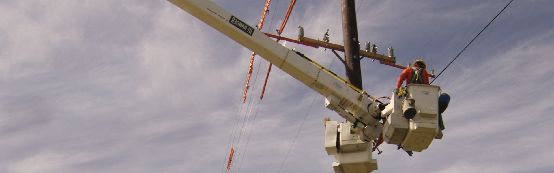 Image of an Idaho Power employee working on a power line