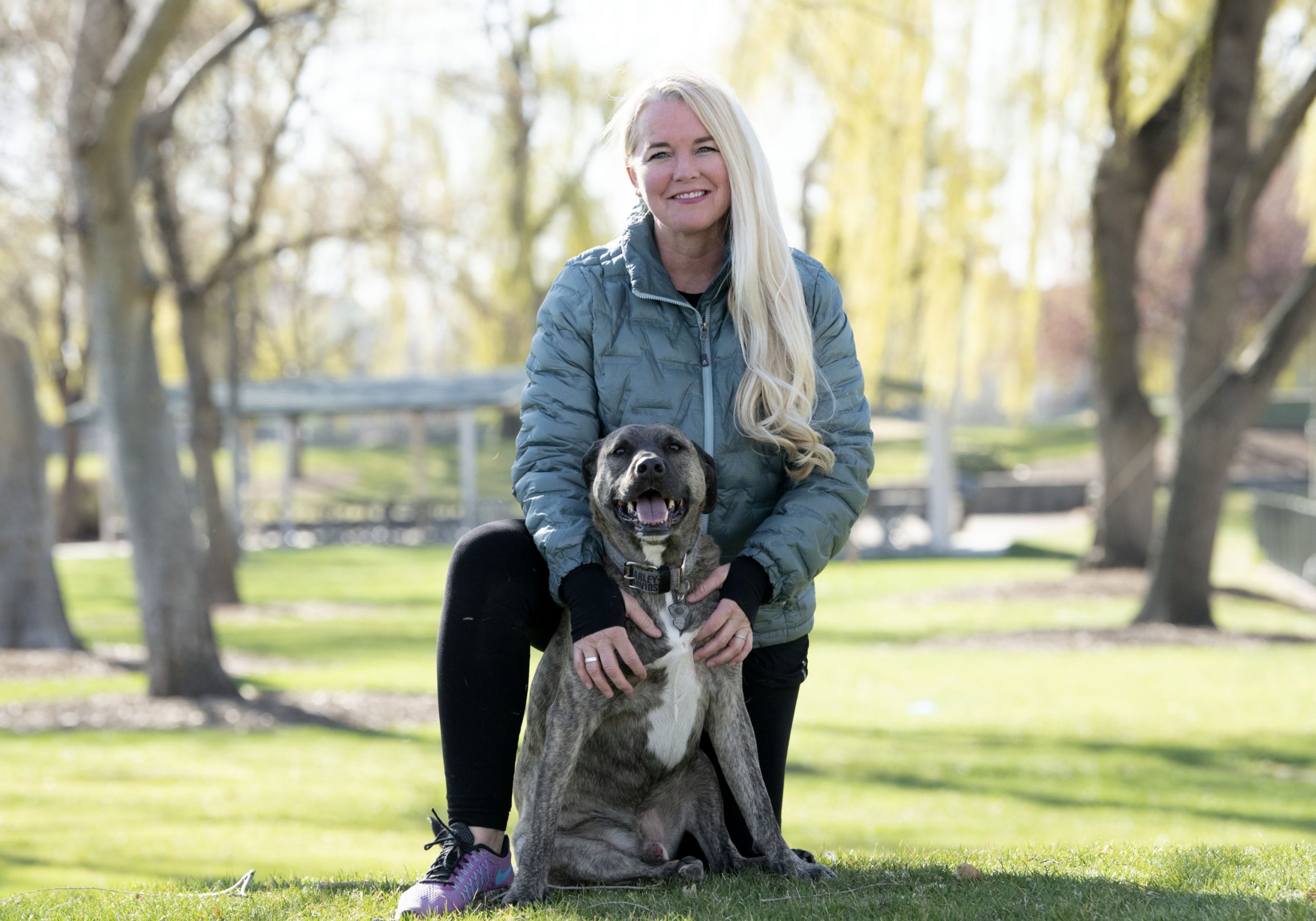 A picture of Michelle Glaze posing with her dog