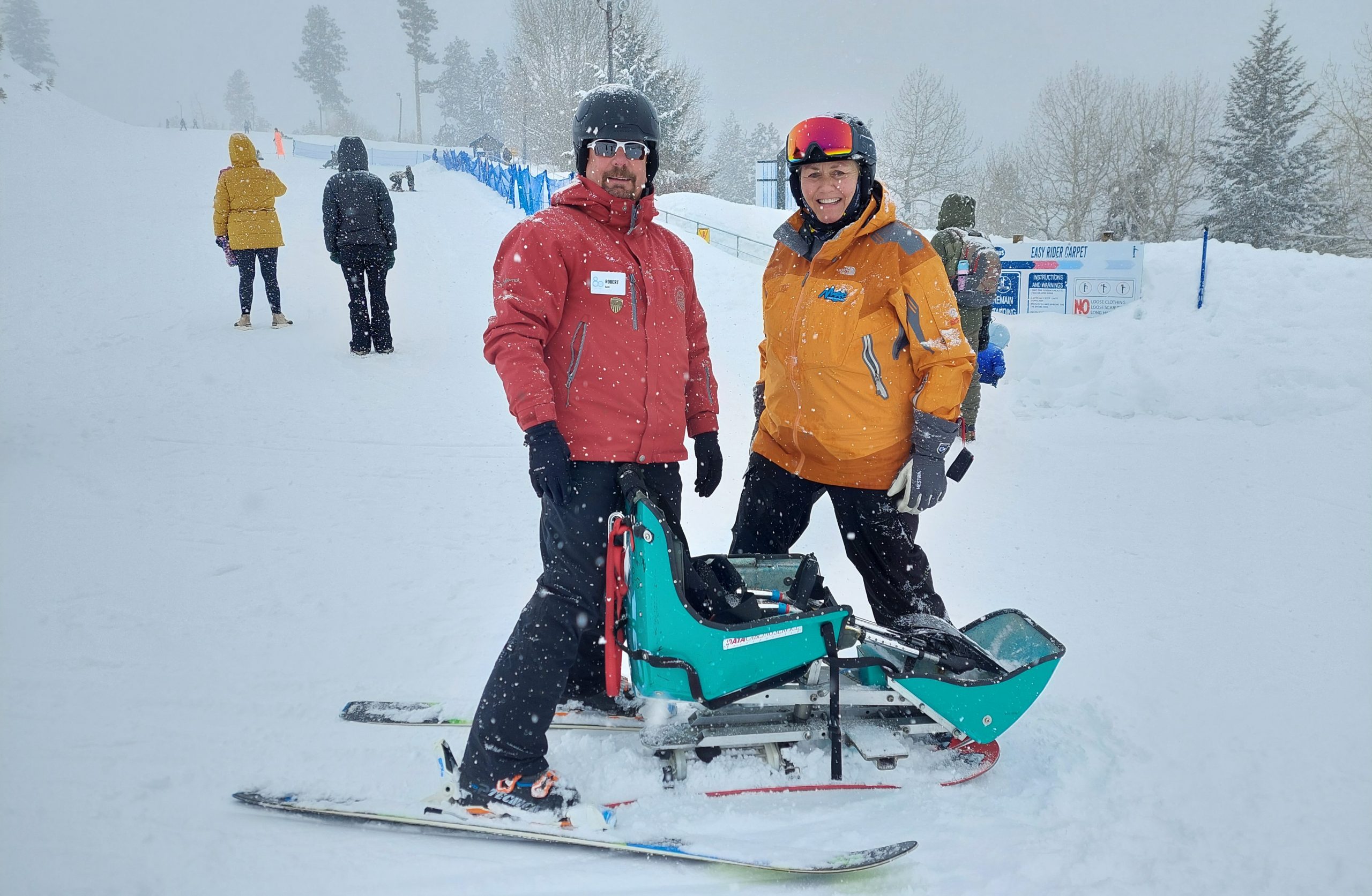man using adaptive ski device