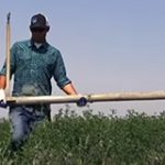 Permalink to Important Safety Reminders for Agricultural Workers Ag worker carrying an irrigation pipe horizontally in the field