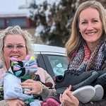 Permalink to Idaho Power Helps Make the Holidays Brighter for Neighbors in Need Four Idaho Power female employees holding socks, shoes and other donations